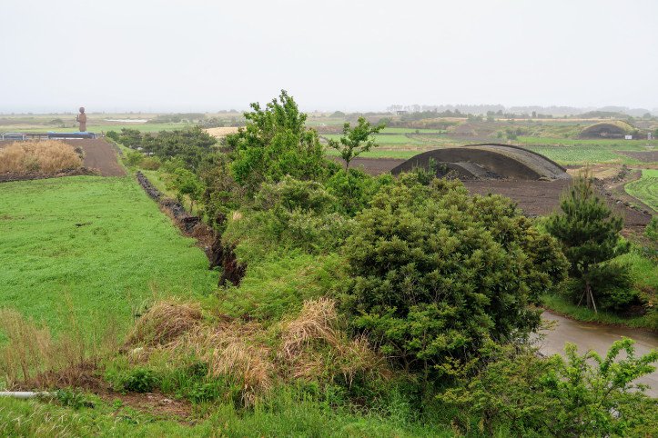 View of concrete military aircraft hangars at Altteureu Airfield.